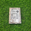 A refurbished Dell 600GB 15k RPM 6Gbps SFF serial hard disk placed on a grassy surface.
