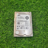 A refurbished Dell 600GB 15k RPM 6Gbps SFF serial hard disk placed on a grassy surface.