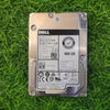 A refurbished DELL 600GB SAS 12Gb 15K 2.5 Inch Hard Disk placed on a grassy surface.