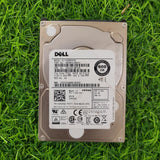 Dell 600GB 10K RPM SAS 12G 2.5-inch hard disk lying on grass.