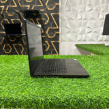 Dell Latitude laptop displayed on green table with side view