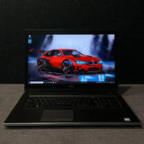 Laptop open on a dark surface with a car design on the screen