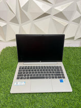 HP ProBook 440 G8 laptop with a silver color scheme, displayed on a grass-like surface
