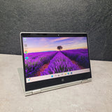 Laptop displaying a lavender field on the screen against a dark background