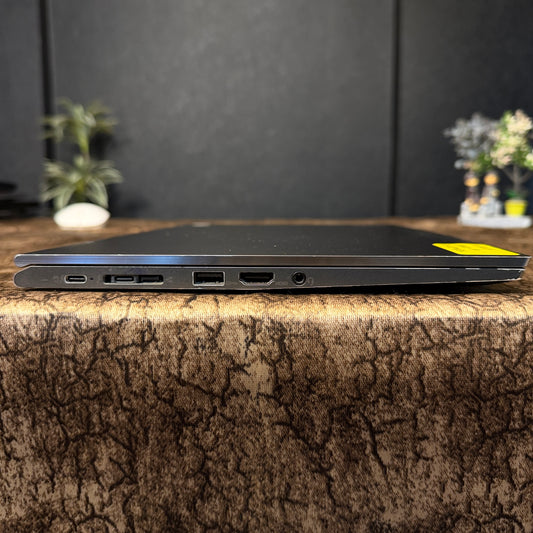 Laptop on a textured surface with a blurred background