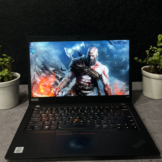 Laptop on a dark surface with a graphic design on the screen