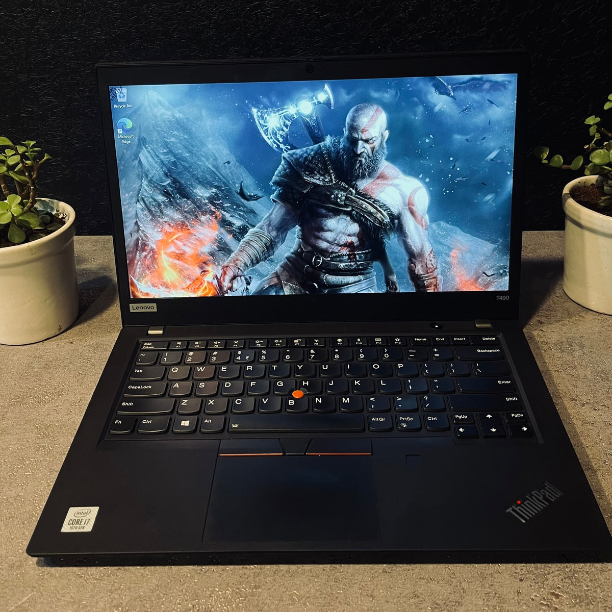 Laptop displaying a video game on a dark background