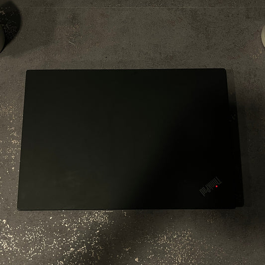 Black mouse pad on a textured gray surface