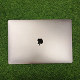 An Apple MacBook Pro  displayed on a grassy surface