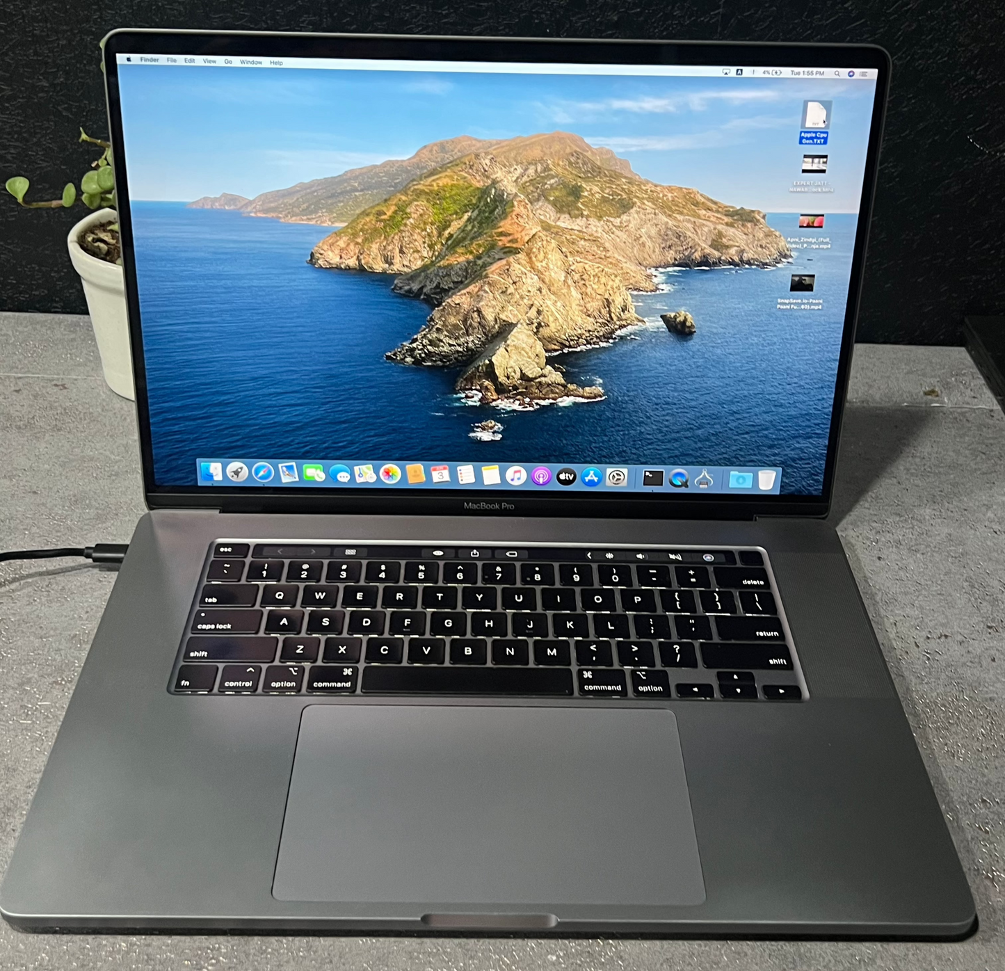 Laptop on a table with an island scenic displayed on the screen