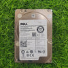 Dell 2.5-inch SAS hard drive with model details and barcodes visible, placed on a grassy surface.