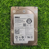 Dell 2.5-inch SAS hard drive with model details and barcodes visible, placed on a grassy surface.
