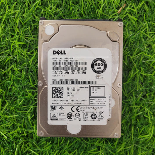 Dell 600GB 10K RPM SAS 12G 2.5-inch hard disk lying on grass.