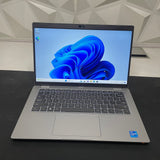 Dell Latitude 5420 laptop with a 14-inch FHD touchscreen display, open and displaying blue wallpaper.