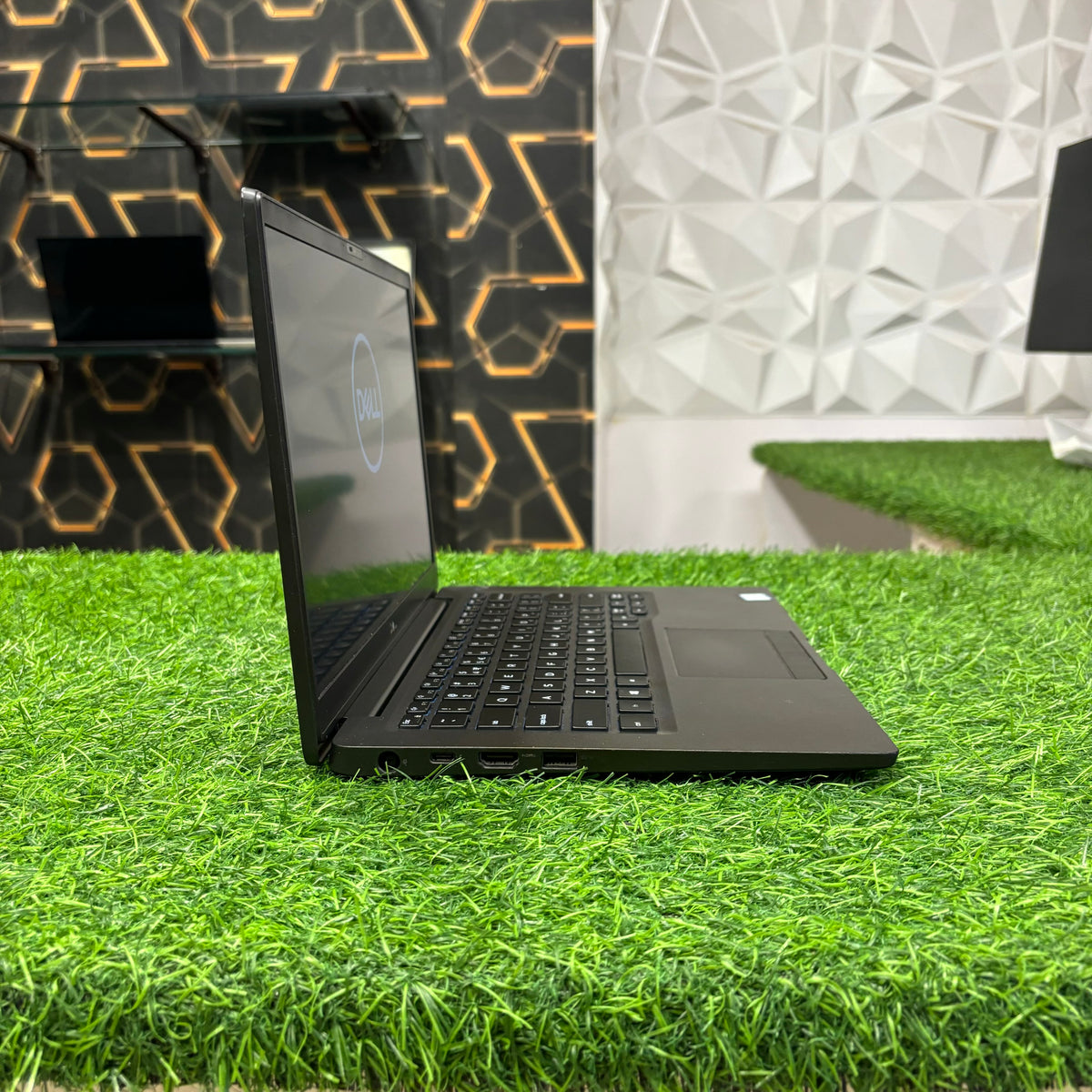 Dell Latitude laptop displayed on green table with side view