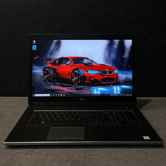 Laptop open on a dark surface with a car design on the screen