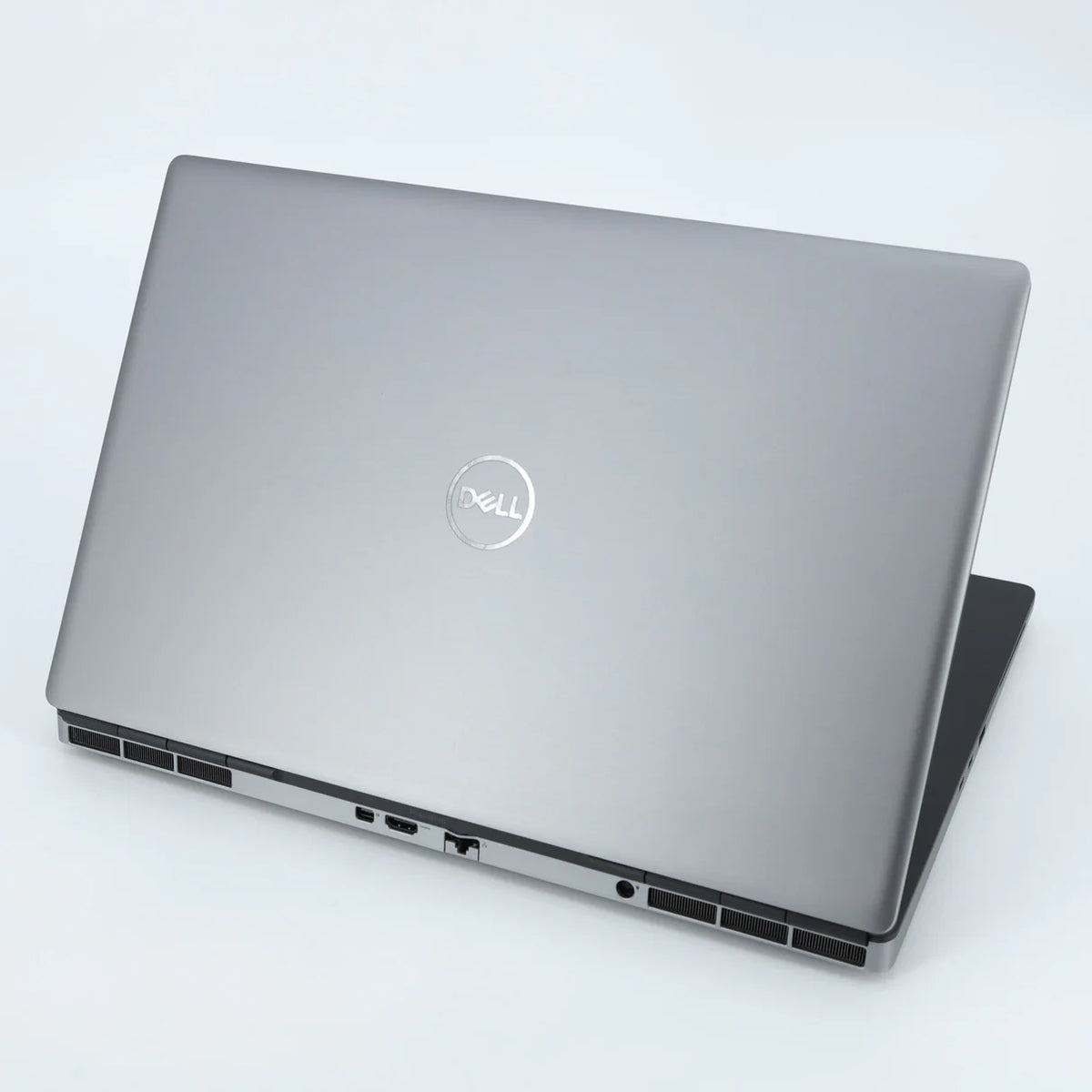 Silver Dell laptop on a light gray background