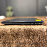 Laptop on a textured surface with a blurred background