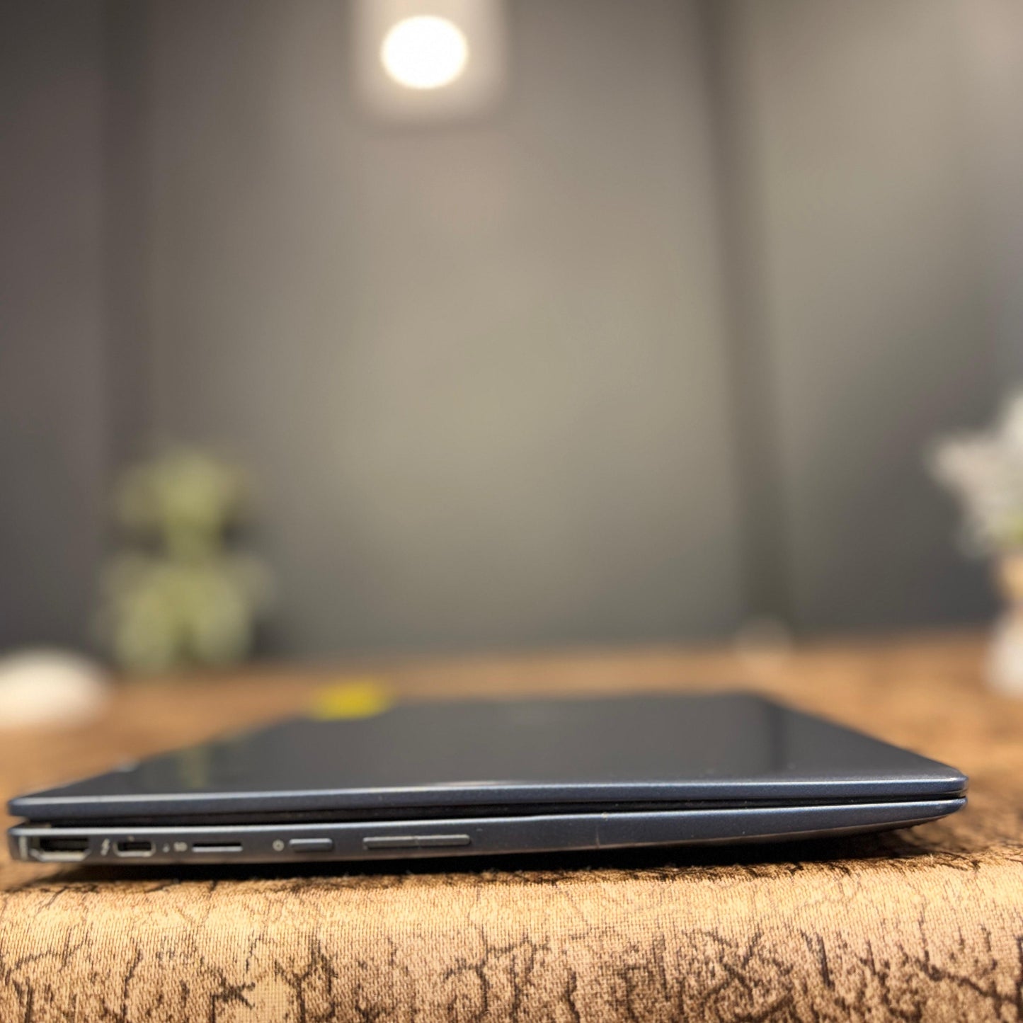 Laptop on a wooden surface with a blurred background
