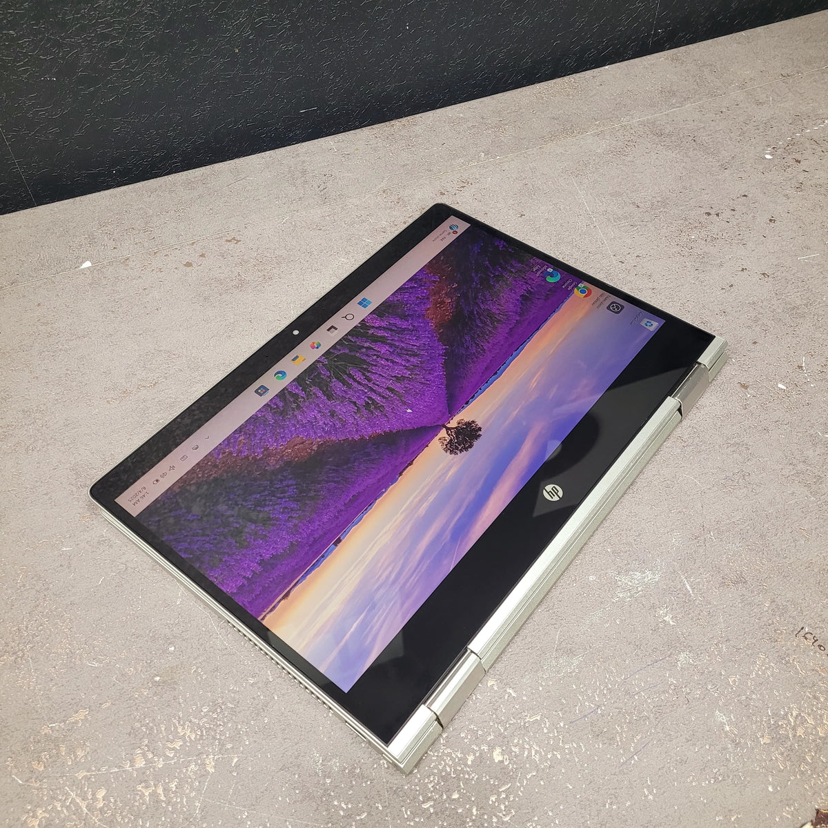 Laptop on a concrete surface with a butterfly wallpaper
