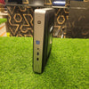 HP T628 Thin Client Computer standing upright on a grass-like surface, showcasing its side profile which includes ports and branding.