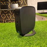 HP t638 Thin Client Computer placed on a grass-like surface, showing its black casing with a textured design.