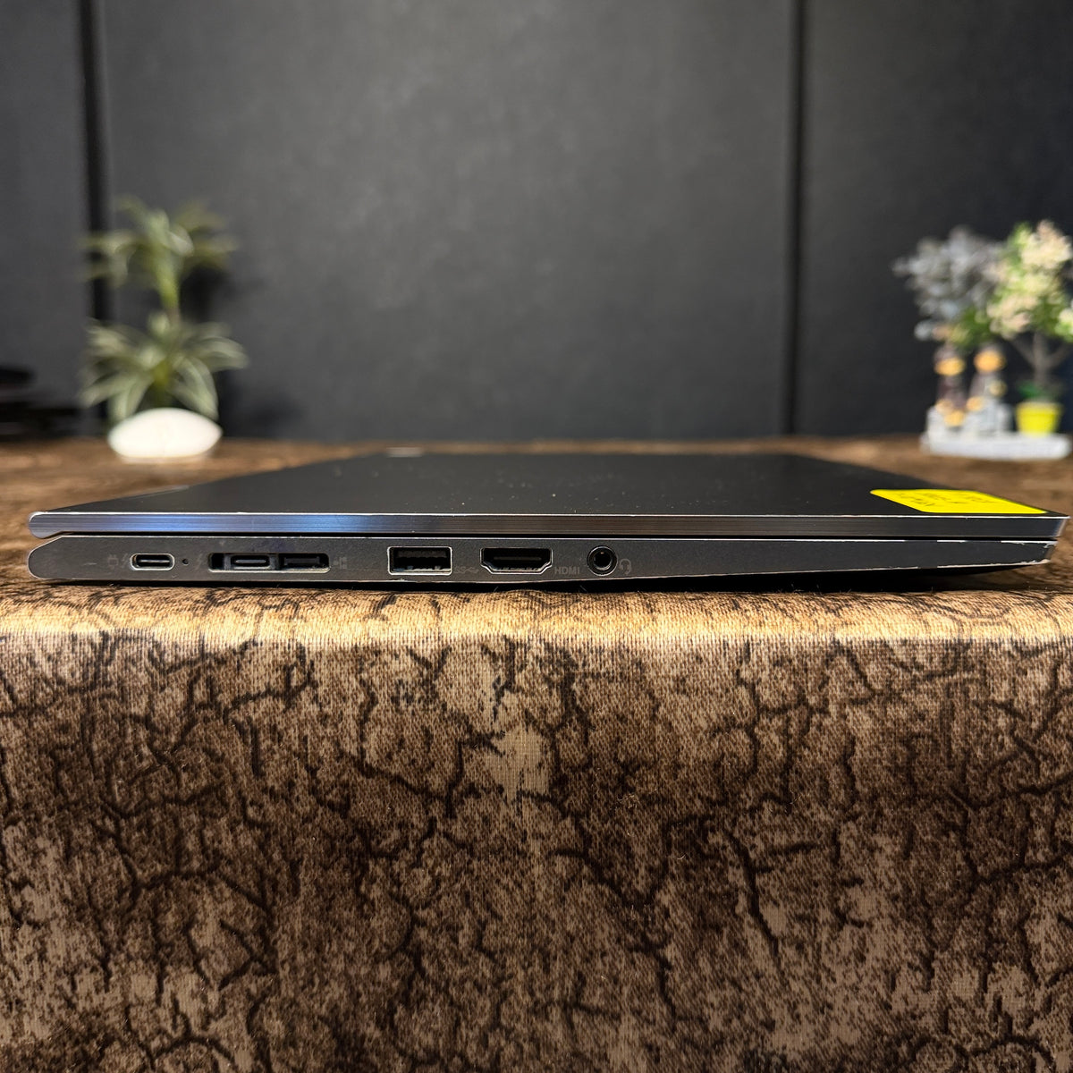 Laptop on a textured surface with a blurred background