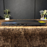 Laptop on a textured surface with a blurred background