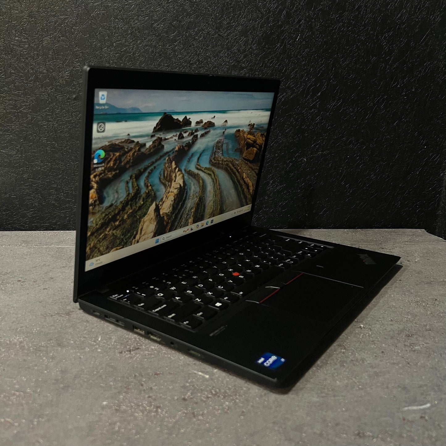 Laptop on a gray surface with a dark background