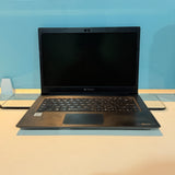 A black Lenovo laptop with an open screen, placed on a light-colored surface against a blue background.