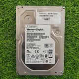 Western Digital 8TB SAS 3.5 inch hard disk placed on a grassy surface.